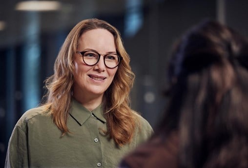 A woman talking to a colleague portrait