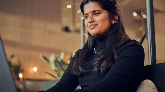 woman working on laptop smiling portrait