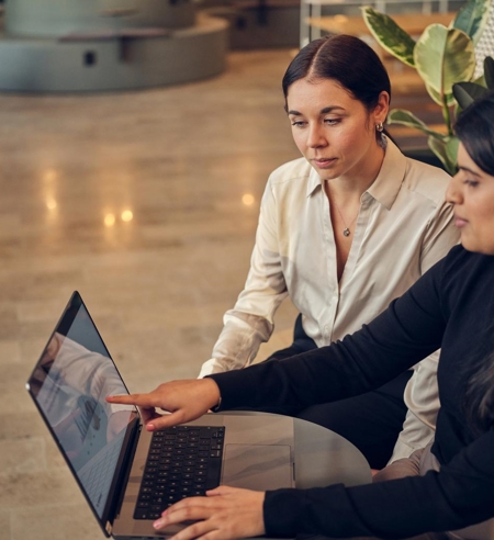 Two women working on laptop